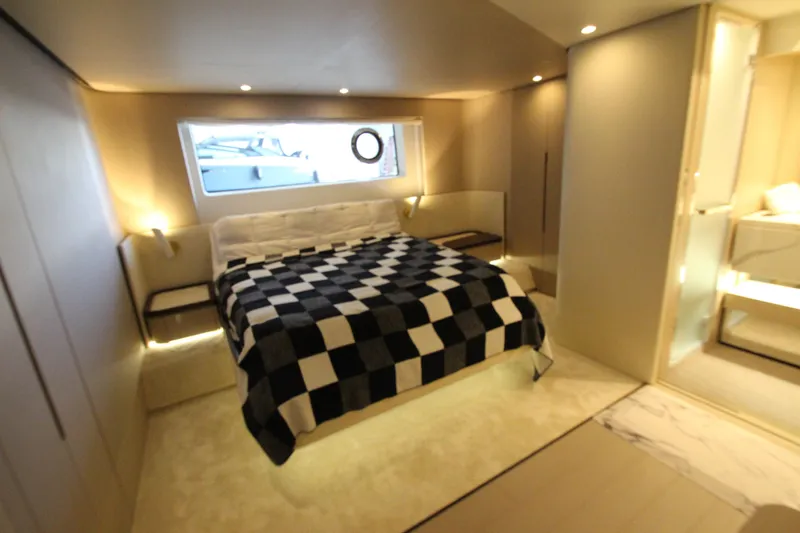 Slide: The Image of Luxurious bedroom interior of 2023 Azimut Fly 68 yacht with modern design and checkered bedding. - 63