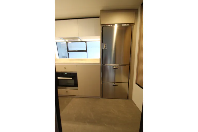 Slide: The Image of Modern kitchen interior of 2023 Azimut Fly 68 yacht with stainless steel appliances. - 20