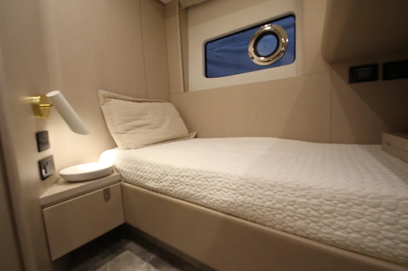 Slide: The Image of Luxurious cabin interior of 2023 Azimut Fly 68 yacht, featuring a cozy bed and modern design. - 39
