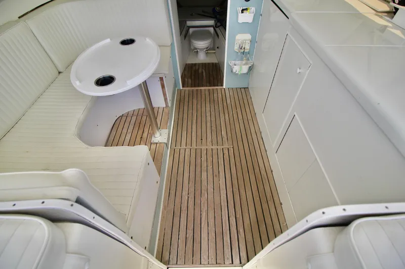 Slide: The Image of Interior of a 1970 Bertram 31 Sportfisher with wood flooring and white seating. - 10