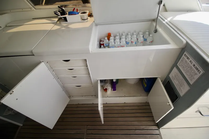 Slide: The Image of 1970 Bertram 31 Sportfisher interior with storage, cooler, and safety instructions. - 12