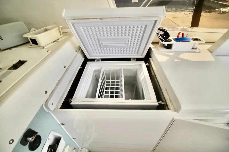 Slide: The Image of Open freezer compartment on a 1970 Bertram 31 Sportfisher boat interior. - 13