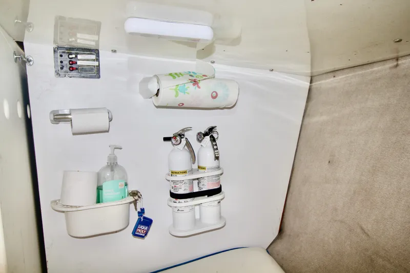 Slide: The Image of Interior of a 1970 Bertram 31 Sportfisher with safety equipment and hygiene supplies. - 16