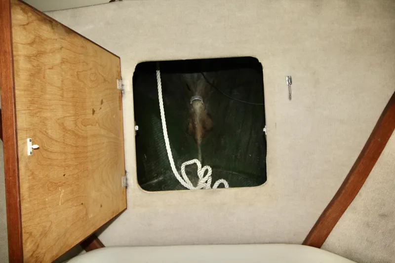 Slide: The Image of Open wooden hatch on 1970 Bertram 31 Sportfisher, revealing interior storage with rope. - 18