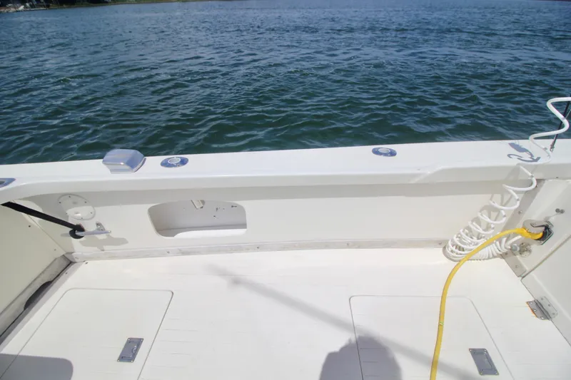 Slide: The Image of 1970 Bertram 31 Sportfisher boat deck with ocean view and coiled hose. - 24