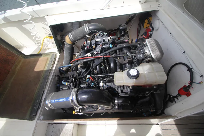 Slide: The Image of Engine compartment of a 1970 Bertram 31 Sportfisher boat, showcasing detailed mechanical components. - 25