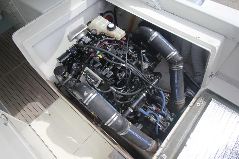 Slide: The Image of Engine compartment of a 1970 Bertram 31 Sportfisher boat, showcasing detailed mechanical components. - 29