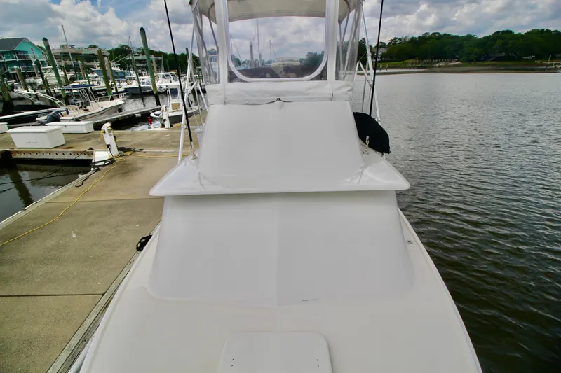 Slide: The Image of 1970 Bertram 31 Sportfisher docked at marina, showcasing sleek design and spacious deck. - 30