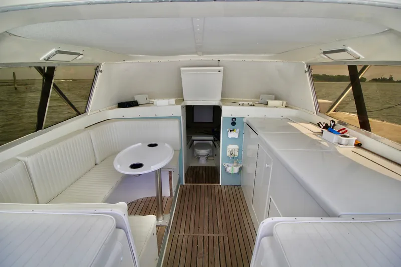 Slide: The Image of Interior of a 1970 Bertram 31 Sportfisher boat with seating and wooden flooring. - 9
