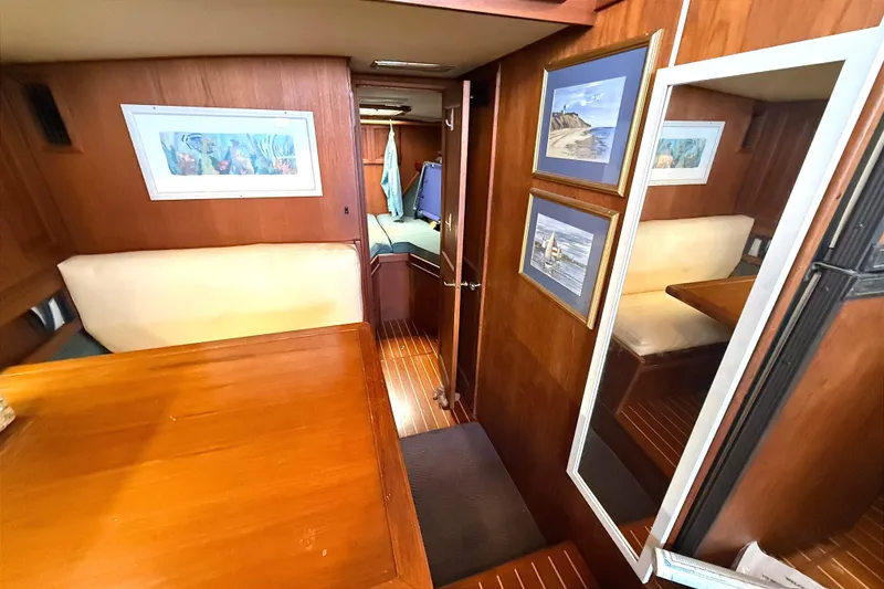 Slide: The Image of Interior of 1986 Viking 35 Convertible yacht with wood paneling and framed artwork. - 10
