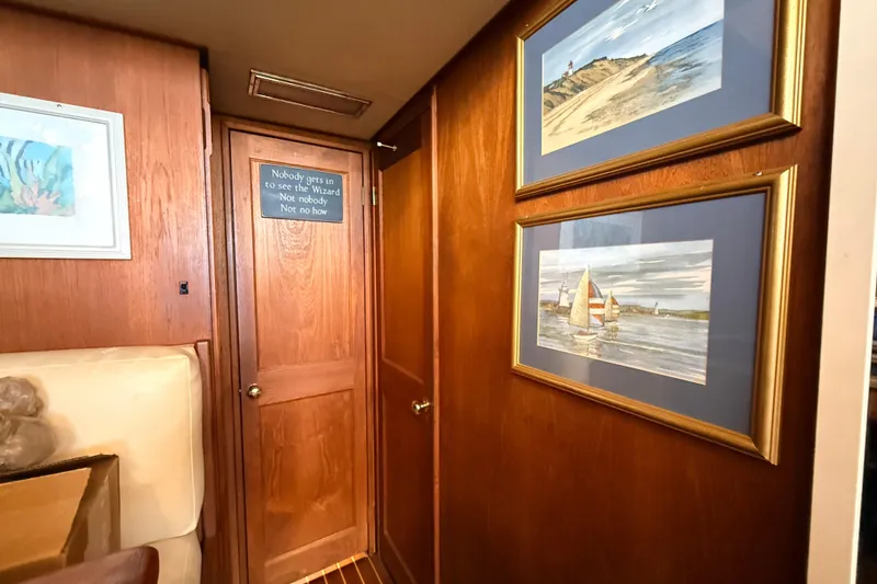Slide: The Image of Interior of 1986 Viking 35 Convertible with nautical artwork and wooden paneling. - 14