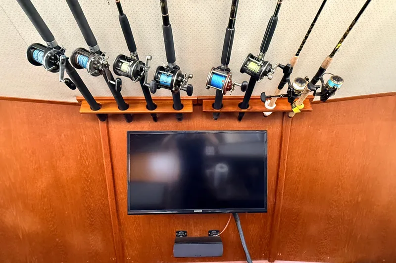 Slide: The Image of Fishing rods and TV setup inside a 1986 Viking 35 Convertible boat. - 15