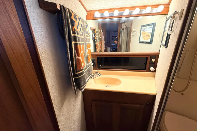 Slide: The Image of Bathroom interior of 1986 Viking 35 Convertible yacht with sink and mirror. - 19