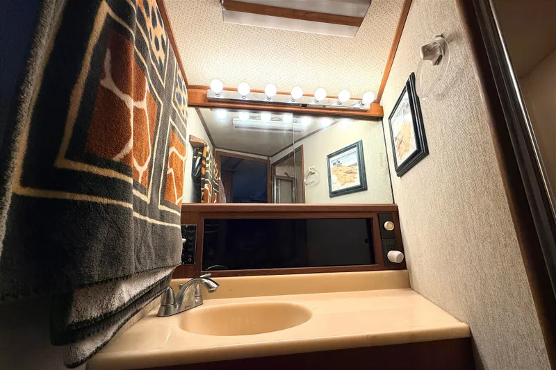 Slide: The Image of Bathroom interior of 1986 Viking 35 Convertible yacht with mirror and lighting. - 20