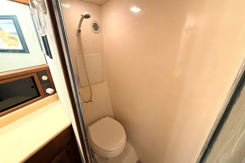 Slide: The Image of 1986 Viking 35 Convertible boat bathroom with shower and toilet. - 21