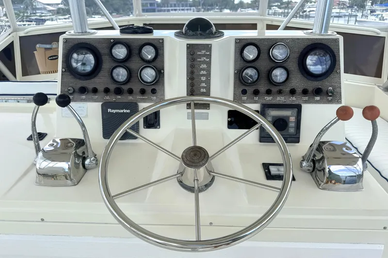 Slide: The Image of 1986 Viking 35 Convertible boat helm with gauges, steering wheel, and controls. - 23