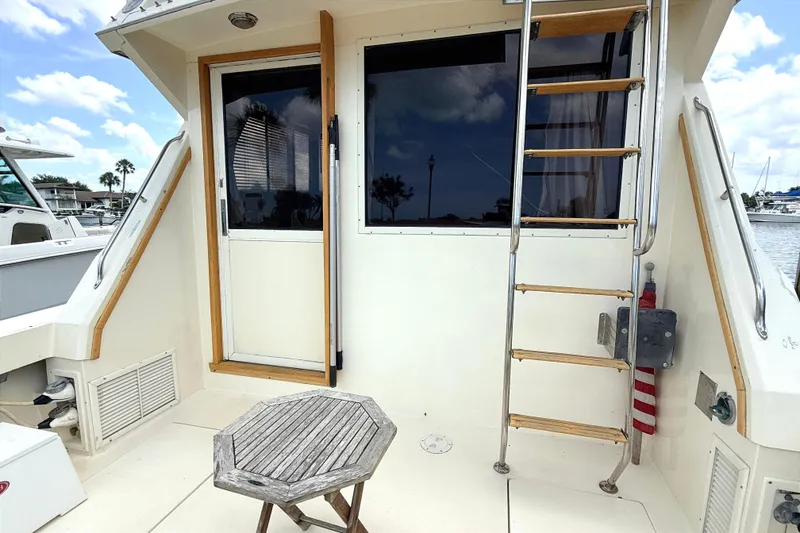 Slide: The Image of 1986 Viking 35 Convertible boat deck with ladder and wooden table. - 4