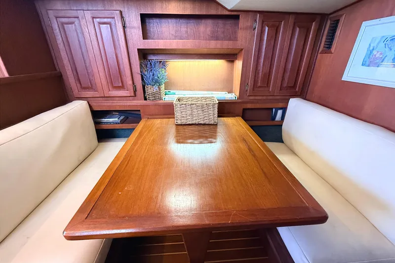 Slide: The Image of Interior of 1986 Viking 35 Convertible yacht with wooden table and cushioned seating. - 9