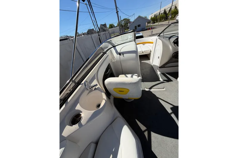 Slide: The Image of 2007 Regal 2400 Bowrider interior with white seating and cup holders. - 12