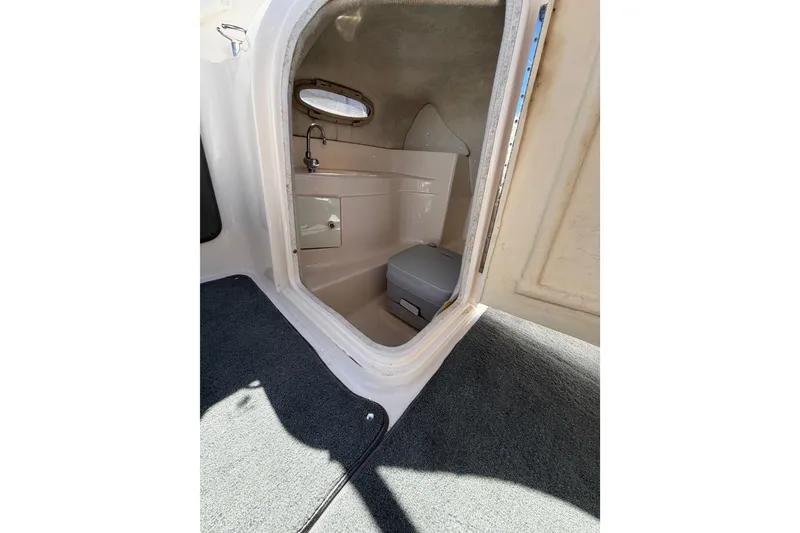 Slide: The Image of Interior view of 2007 Regal 2400 Bowrider boat's compact cabin space. - 18