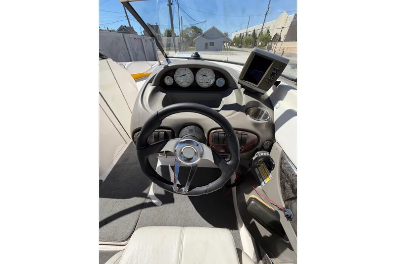 Slide: The Image of 2007 Regal 2400 Bowrider dashboard with steering wheel and gauges in sunlight. - 21