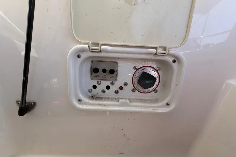 Slide: The Image of Control panel of a 2007 Regal 2400 Bowrider boat with switches and a Perko dial. - 23