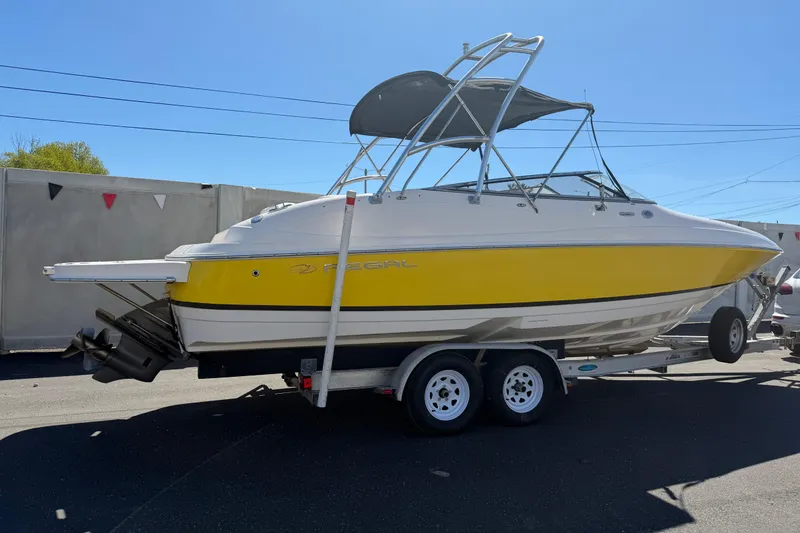 Slide: The Image of 2007 Regal 2400 Bowrider boat with yellow hull on a trailer. - 3