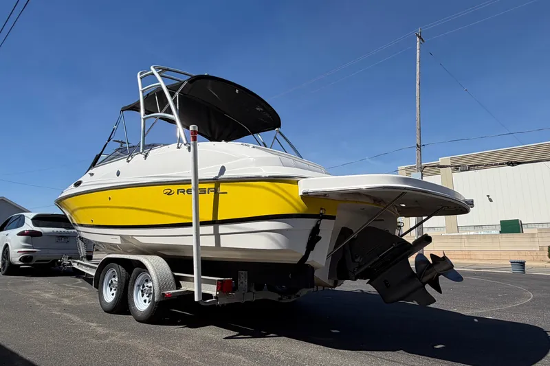 Slide: The Image of 2007 Regal 2400 Bowrider boat with yellow and white exterior on a trailer. - 5