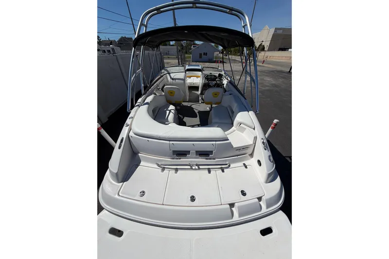Slide: The Image of 2007 Regal 2400 Bowrider boat with spacious seating and sleek design, docked outdoors. - 9
