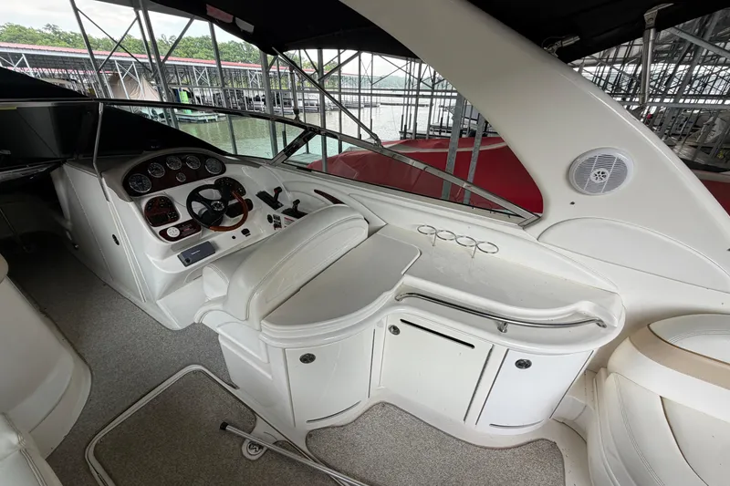 Slide: The Image of 2003 Sea Ray 290 Bowrider interior with helm, seating, and control panel. - 11