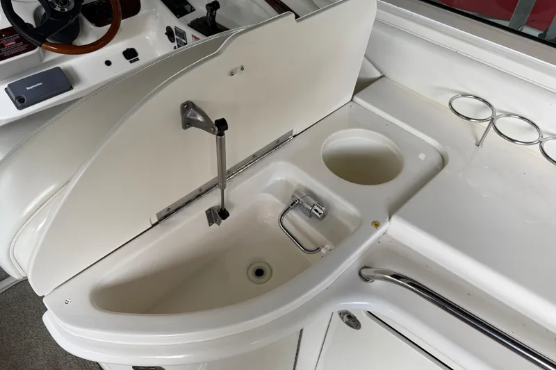 Slide: The Image of 2003 Sea Ray 290 Bowrider boat interior with sink and cup holders. - 12