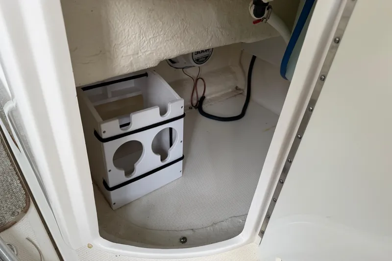 Slide: The Image of Interior storage compartment of a 2003 Sea Ray 290 Bowrider boat. - 13