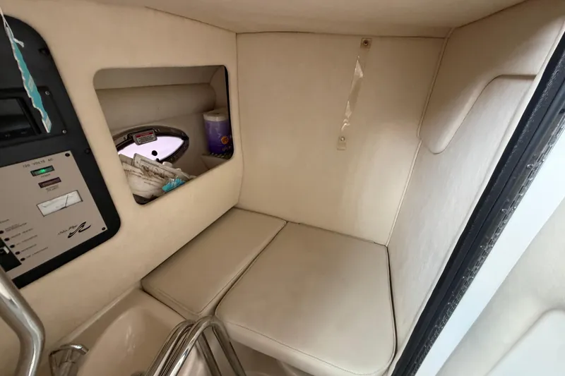 Slide: The Image of 2003 Sea Ray 290 Bowrider cabin interior with seating and control panel. - 18