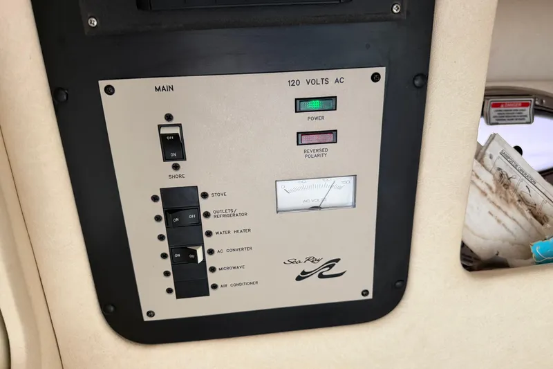 Slide: The Image of Control panel of a 2003 Sea Ray 290 Bowrider boat, showing electrical switches and indicators. - 19