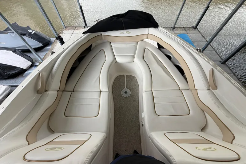 Slide: The Image of 2003 Sea Ray 290 Bowrider interior with white leather seating and water view. - 23
