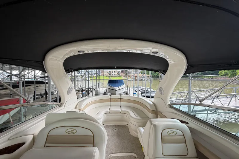 Slide: The Image of 2003 Sea Ray 290 Bowrider interior with seating, docked at marina. - 27