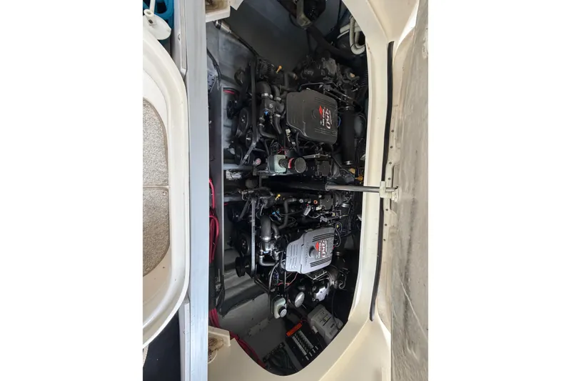 Slide: The Image of Engine compartment of a 2003 Sea Ray 290 Bowrider boat, showcasing dual engines. - 29