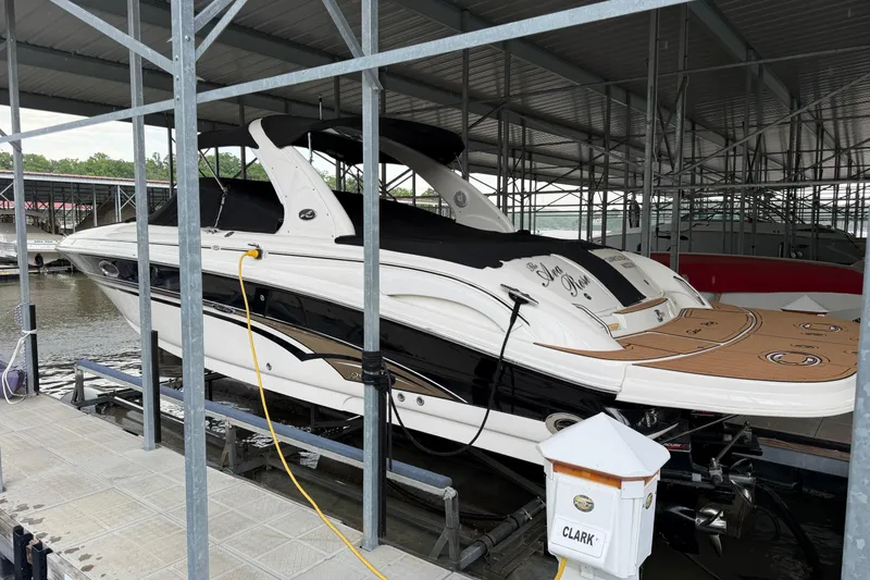 Slide: The Image of 2003 Sea Ray 290 Bowrider docked in a covered marina slip. - 3