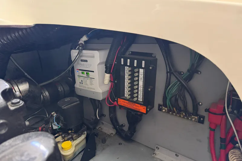 Slide: The Image of Engine compartment of a 2003 Sea Ray 290 Bowrider, showing electrical components and wiring. - 32