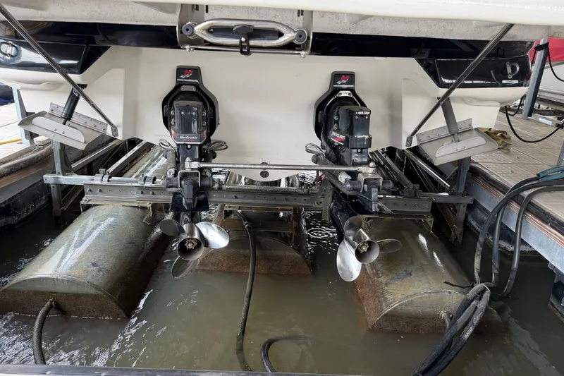 Slide: The Image of 2003 Sea Ray 290 Bowrider with dual propellers in a marina setting. - 5