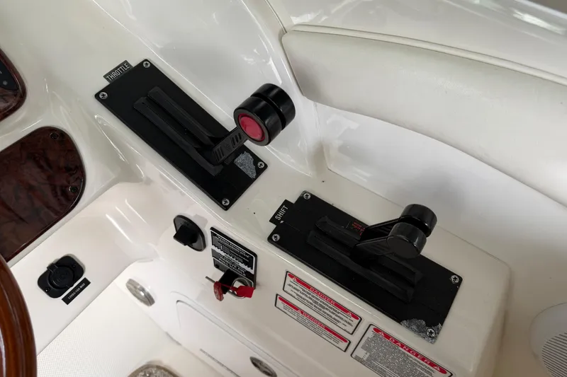 Slide: The Image of Throttle controls on a 2003 Sea Ray 290 Bowrider boat dashboard. - 7