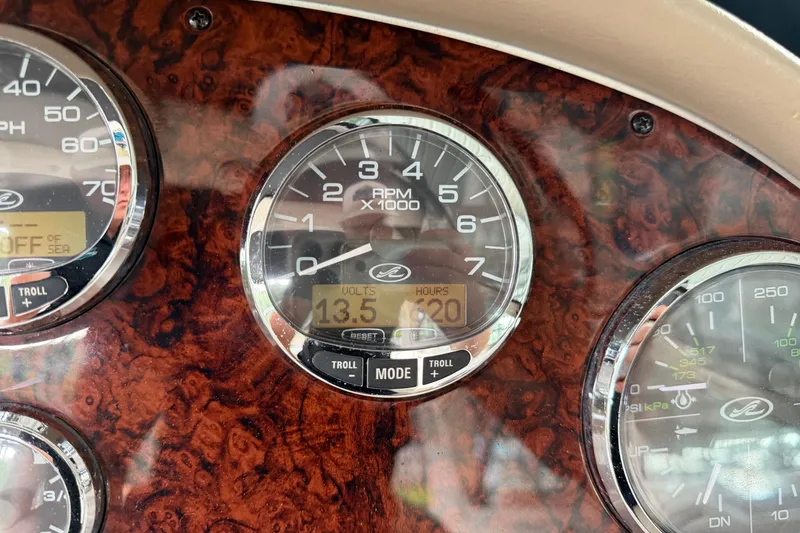 Slide: The Image of Dashboard of a 2003 Sea Ray 290 Bowrider showing RPM and voltage gauges. - 8