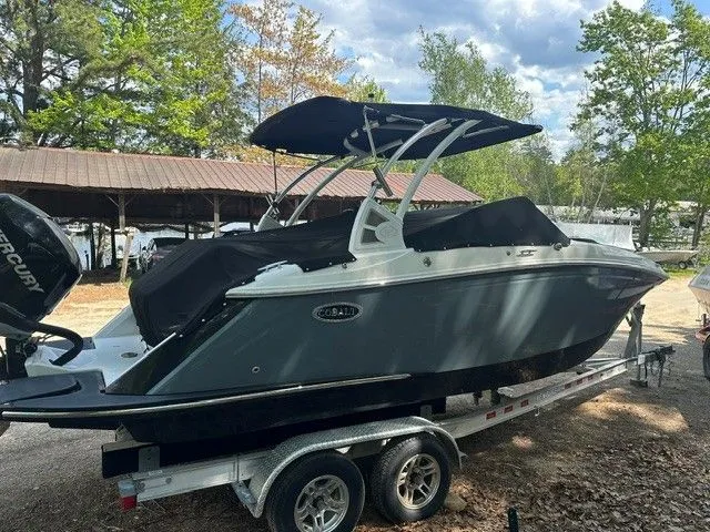 Slide: The Image of 2018 Cobalt 23 SC boat parked on trailer outdoors. - 4