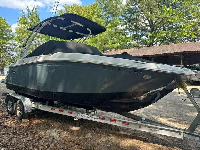 Slide: The Image of 2018 Cobalt 23 SC boat parked on trailer outdoors. - 5
