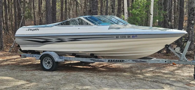 The Image of 2001 Sylvan 186 Sport boat on trailer in forest. - 1