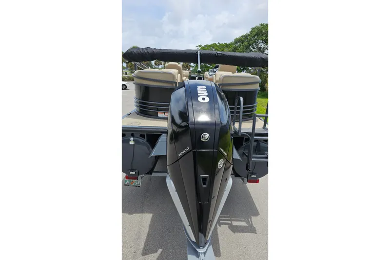 Slide: The Image of 2020 Regency 230 LE3 pontoon boat with powerful outboard motor on trailer. - 16