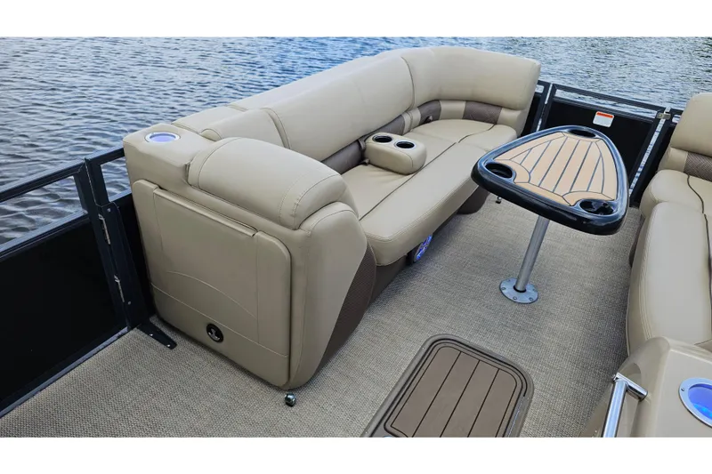 Slide: The Image of Luxurious seating area on 2020 Regency 230 LE3 pontoon boat with table and cup holders. - 20