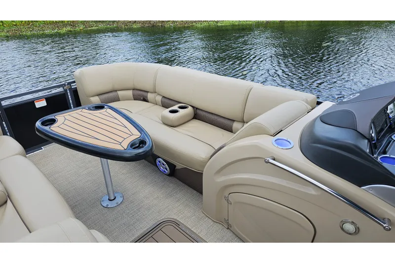 Slide: The Image of Luxurious 2020 Regency 230 LE3 pontoon boat interior with plush seating and table. - 21