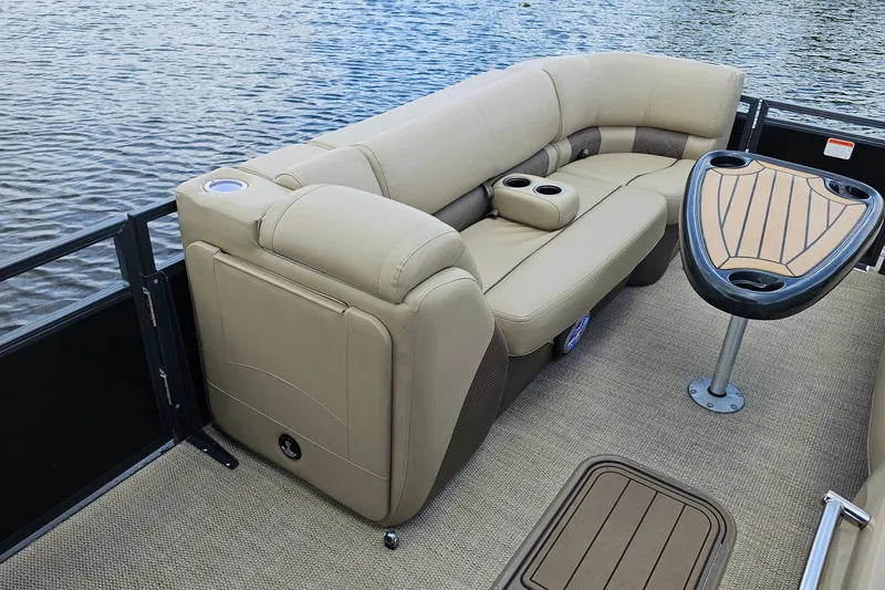 Slide: The Image of Luxurious seating on 2020 Regency 230 LE3 pontoon boat with water view. - 22