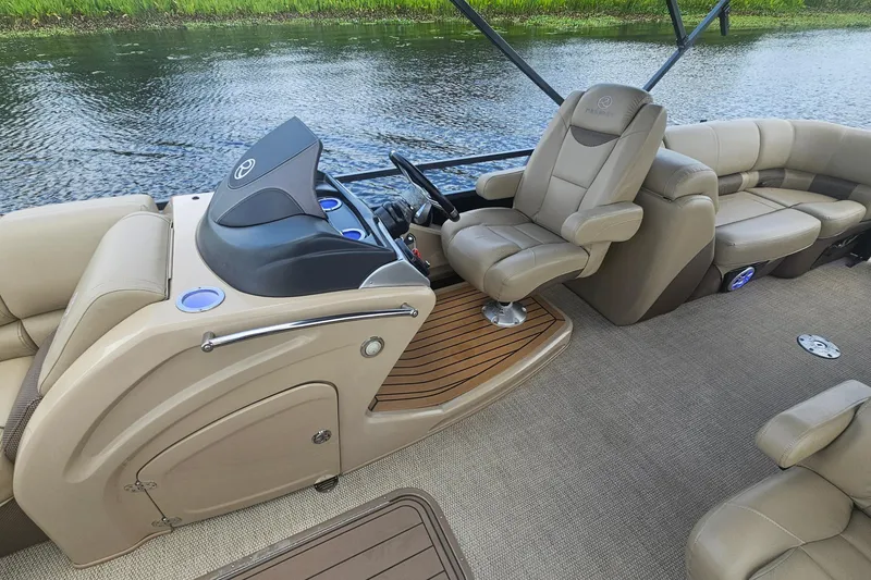 Slide: The Image of Luxurious 2020 Regency 230 LE3 boat interior with plush seating and sleek dashboard design. - 25